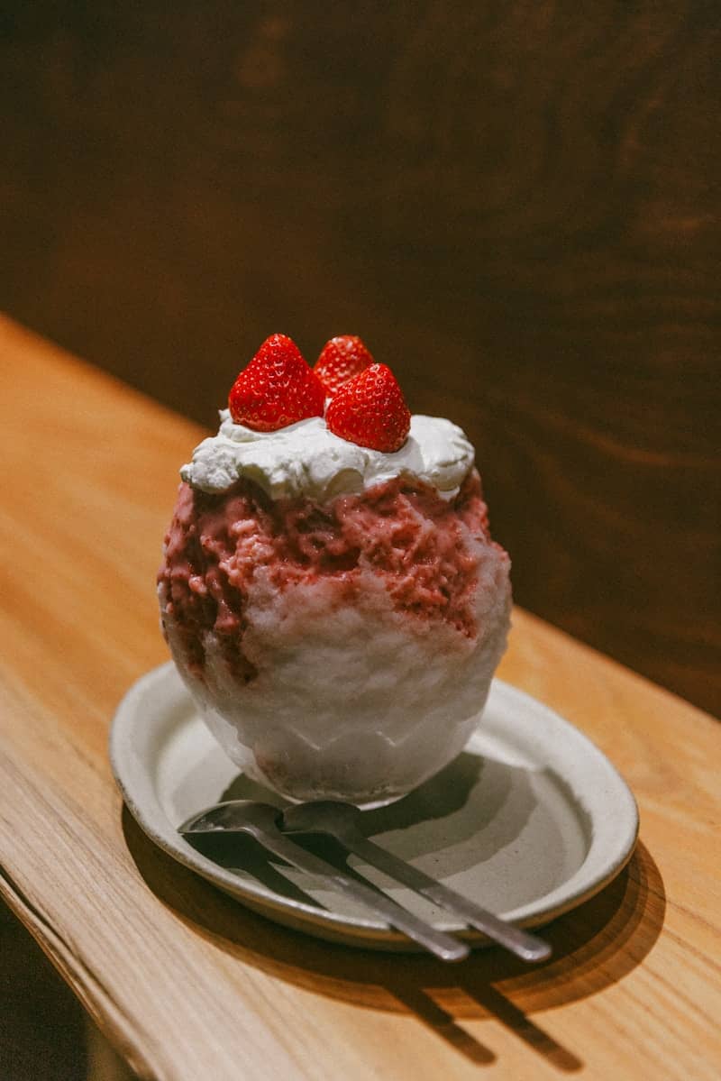 Shaved ice dessert with strawberries and whipped cream