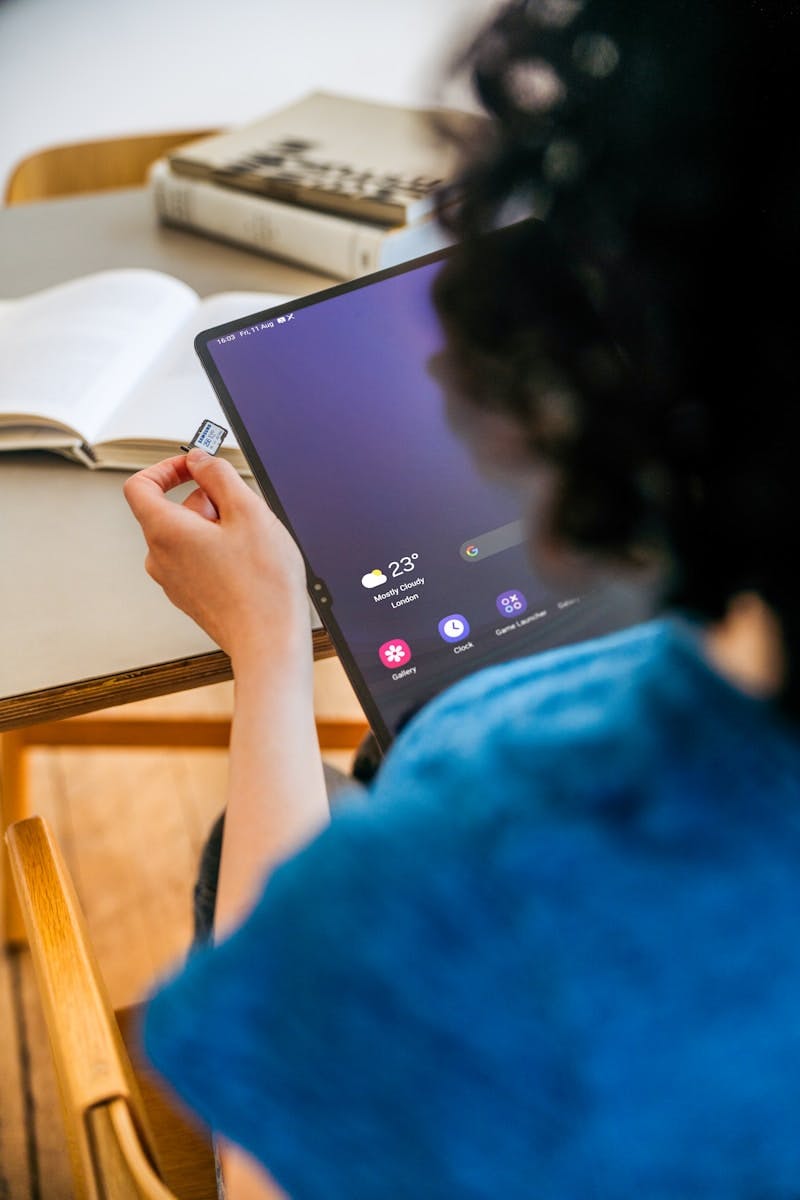 A woman sitting at a table with a laptop computer