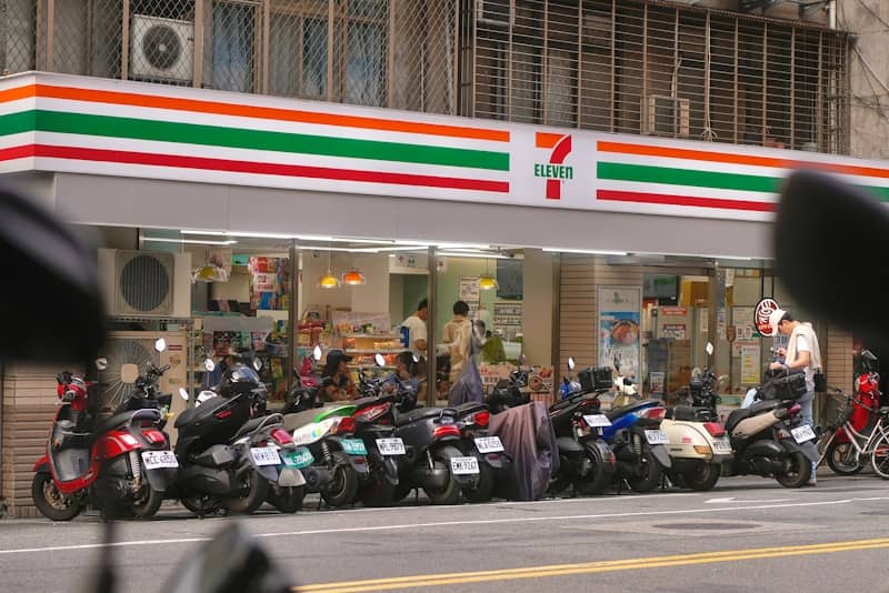 Motorcycles parked outside a 7-eleven store.
