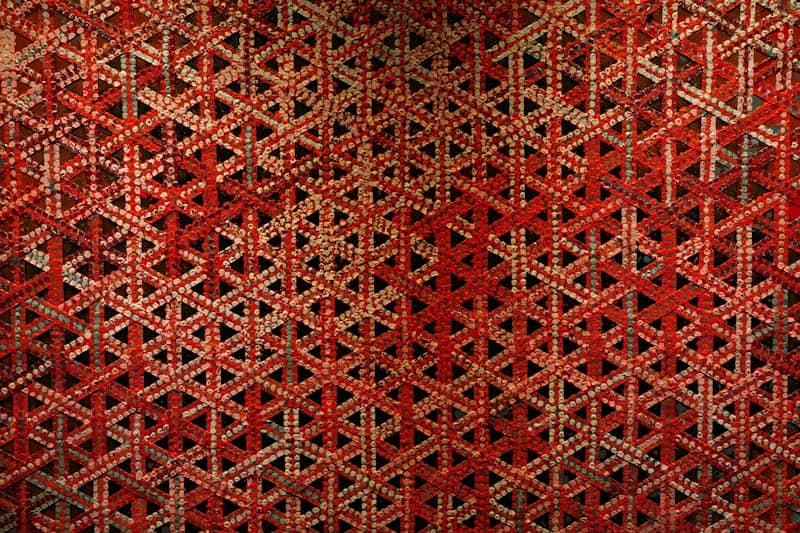 Intricate red and beige geometric woven pattern