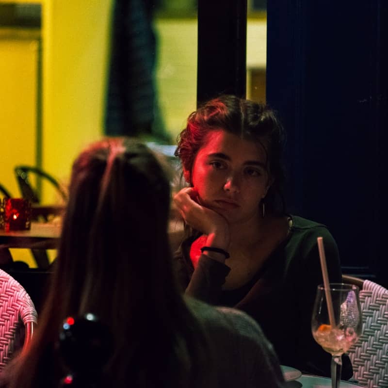 Two women sitting at a table in a restaurant