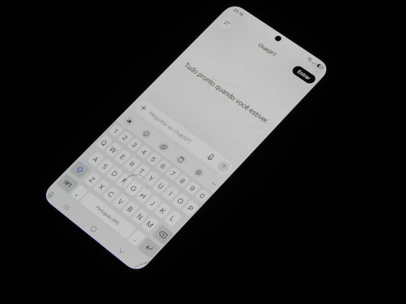 A smartphone screen displaying a chat interface with a virtual keyboard on black