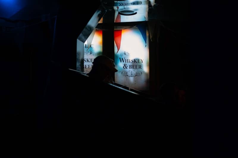 Person silhouetted against a bright sign