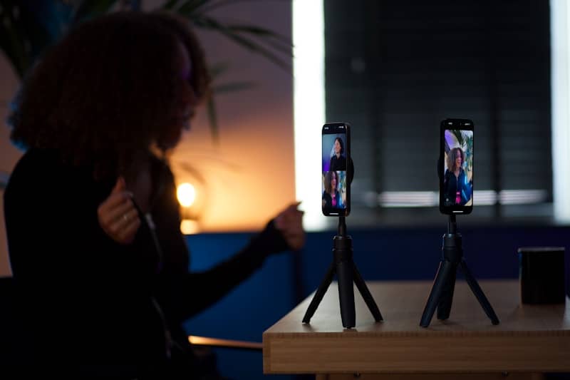 Woman filming herself with two smartphones