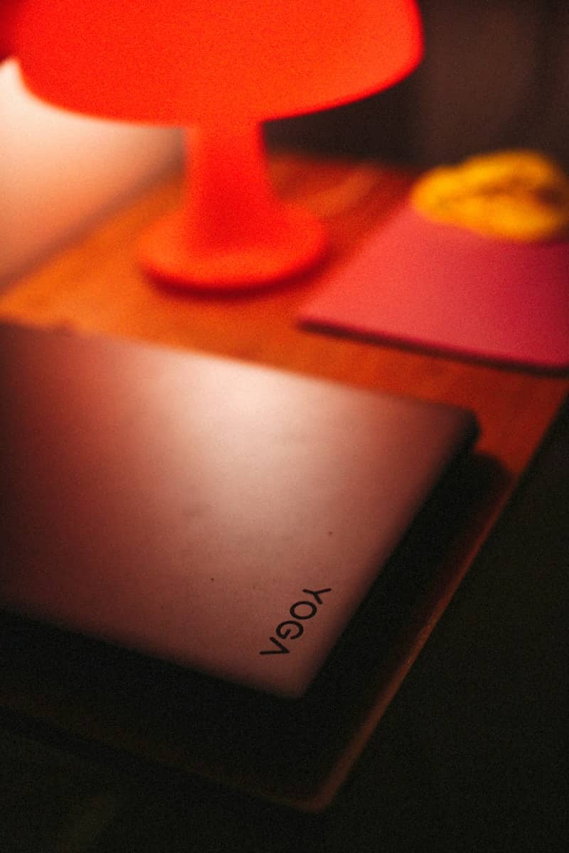 A laptop sits on a nightstand.