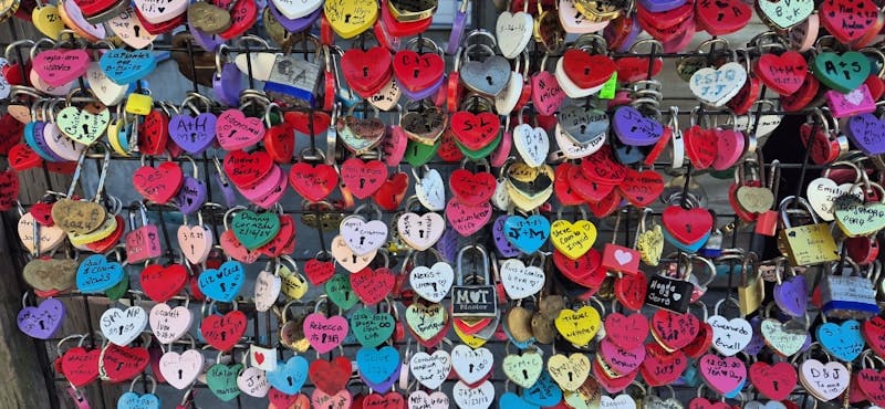 A wall covered in lots of different colored hearts