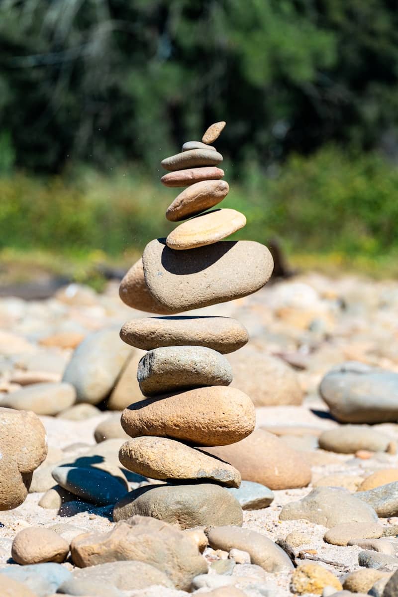 Stack of balanced stones on a rocky shore