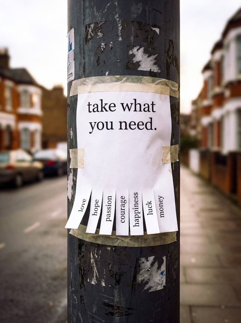 A sign on a pole reads 'take what you need.'