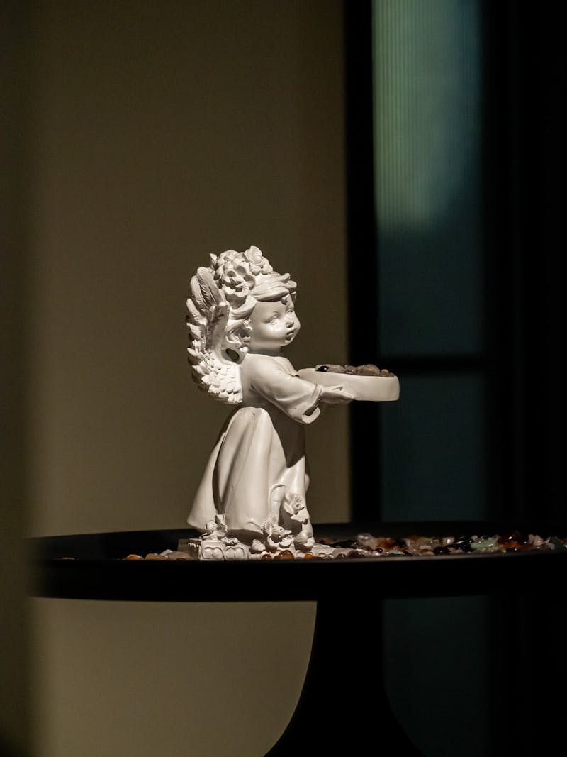 A statue of a girl with a gun on a table