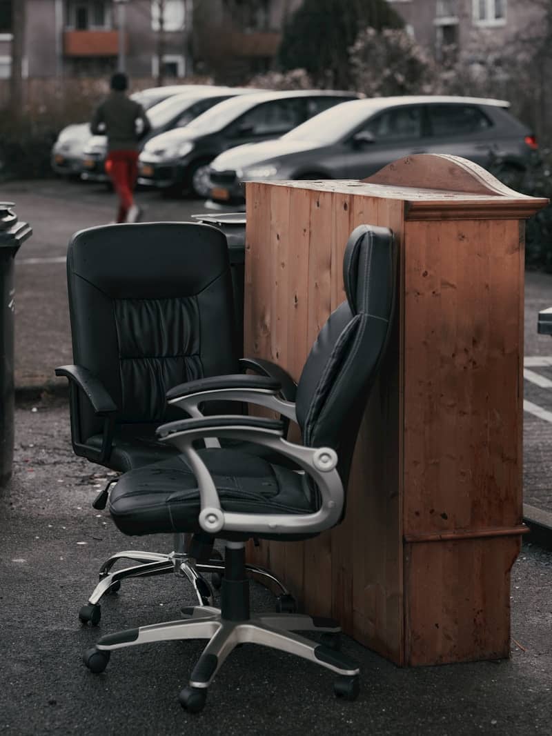 An office chair sitting next to a desk in a parking lot