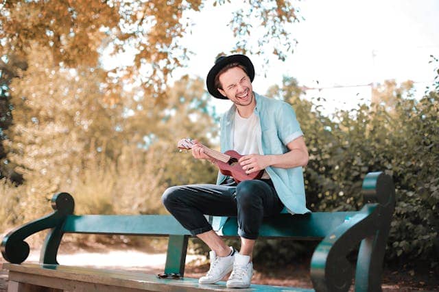 Photo by Andrea Piacquadio: https://www.pexels.com/photo/man-sitting-on-wooden-bench-using-ukulele-3761517/