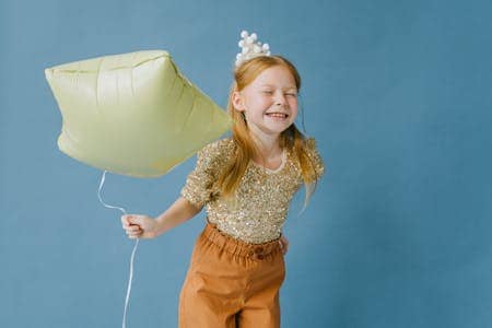 Photo by Ivan Samkov: https://www.pexels.com/photo/smiling-girl-holding-a-star-shaped-balloon-9628353/