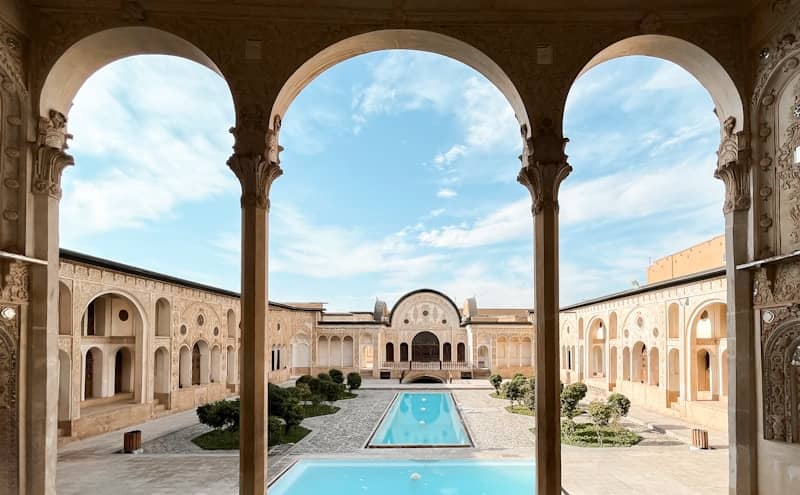 Arches frame the courtyard and pool.
