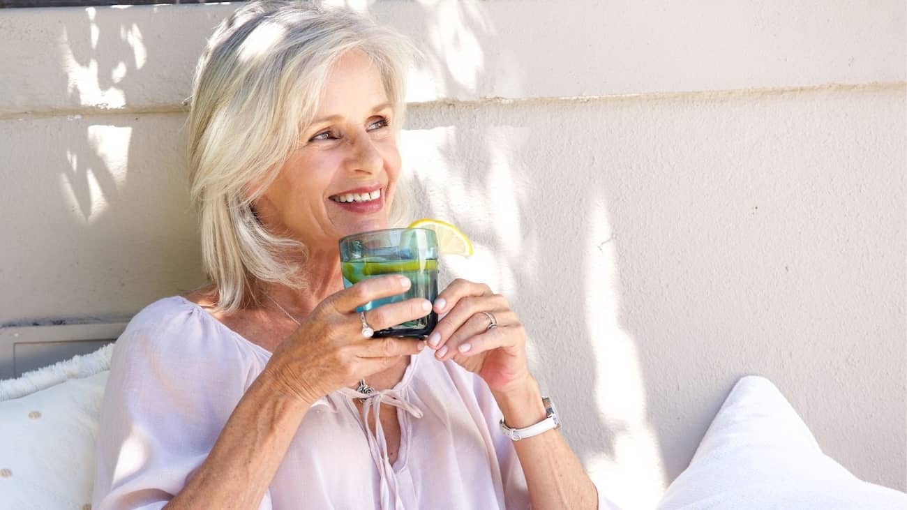 woman smiling and enjoying beverage