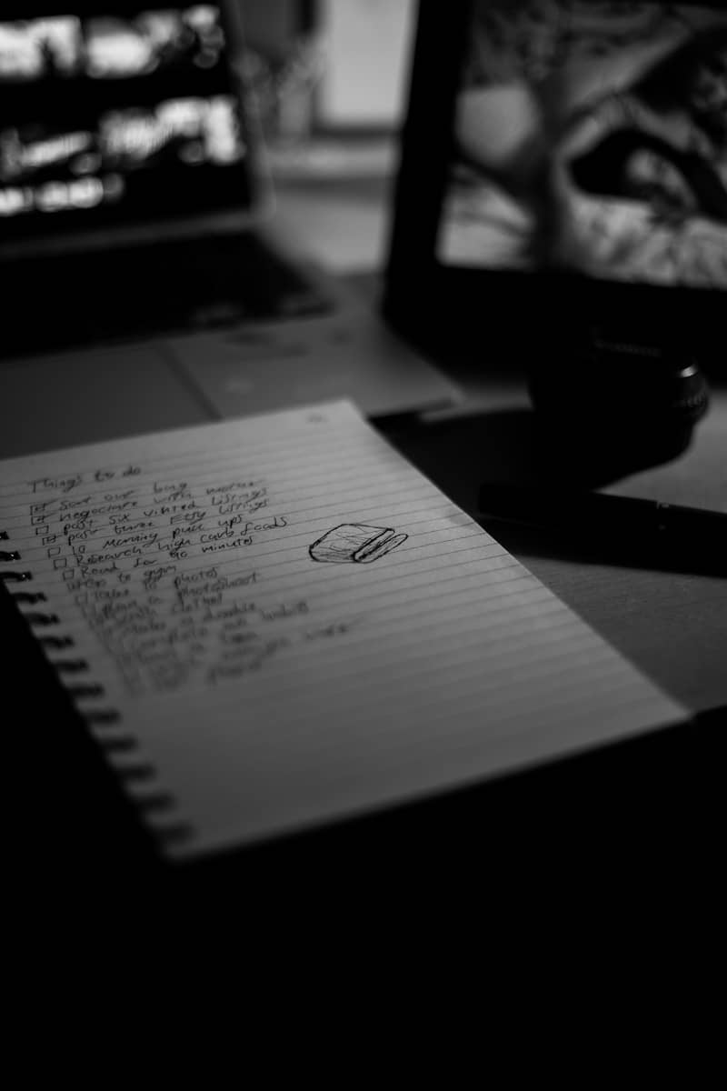 A to-do list sits on a dimly lit desk.