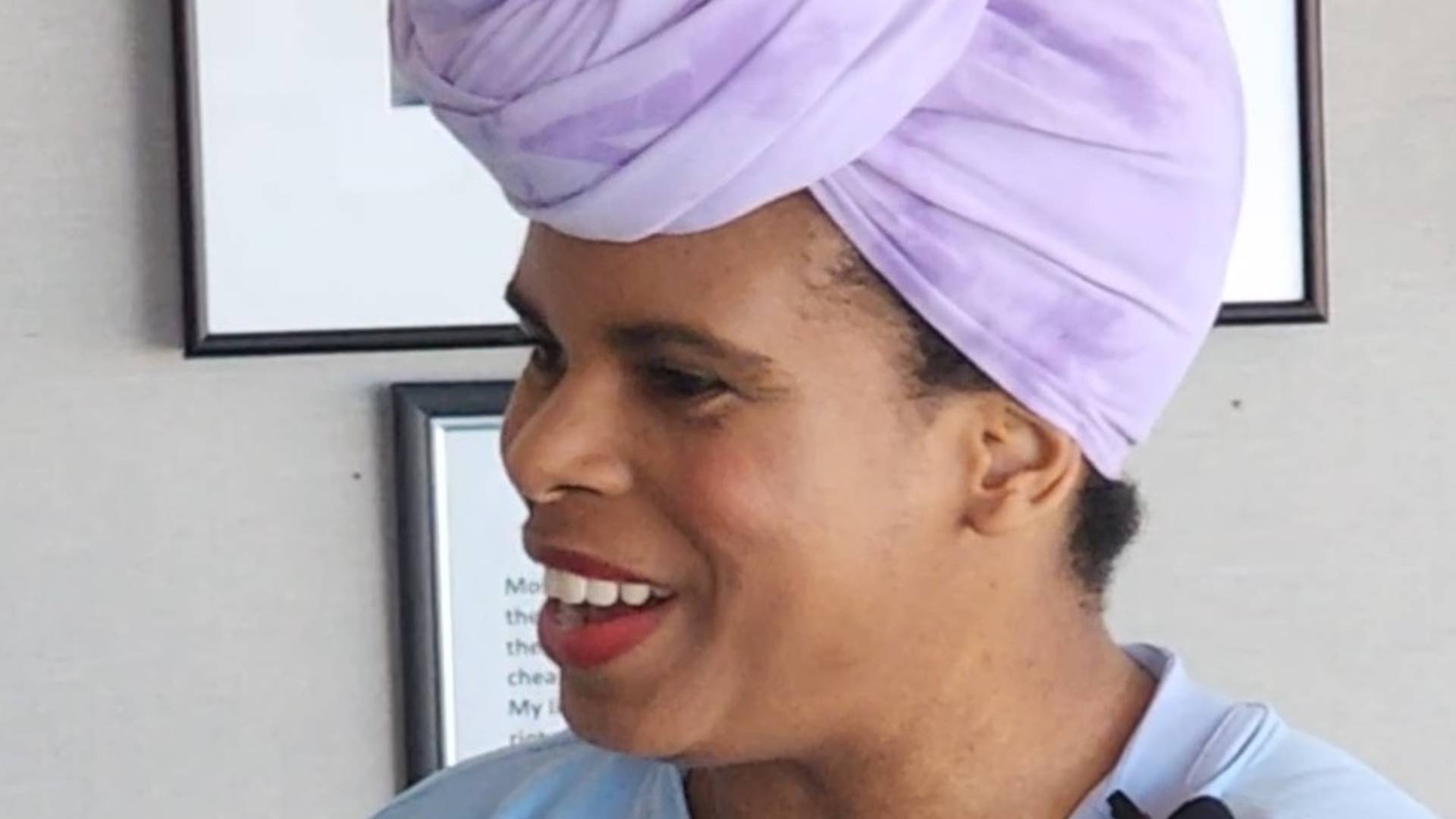 Zaakirah smiles and speaks looking away from the camera