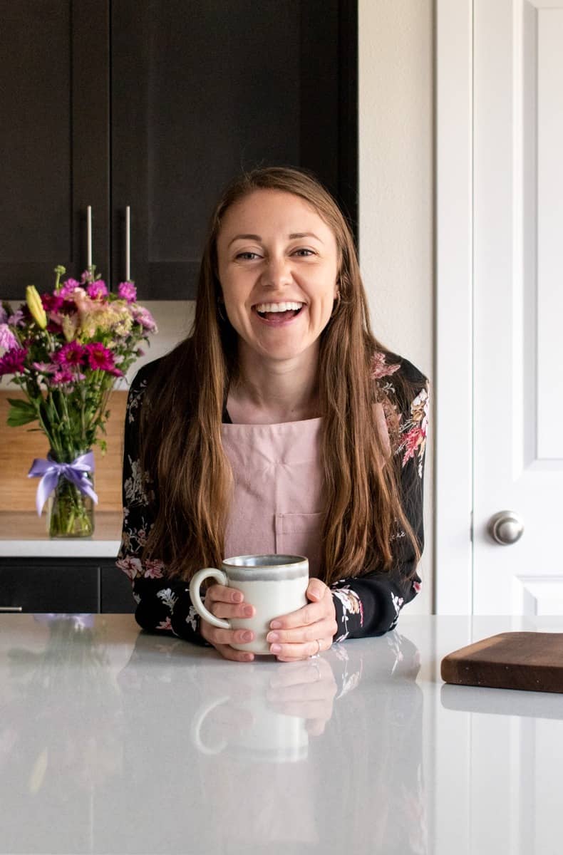 Carissa smiling holding a drink mug