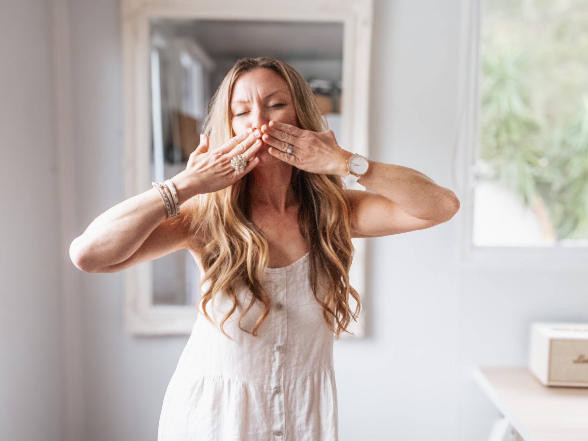 Jo Geaney Copywriter covering her mouth pre blowing a kiss top her subscribers