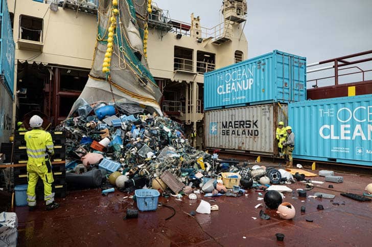 Plastic garbage falling out of a large net on a ship deck