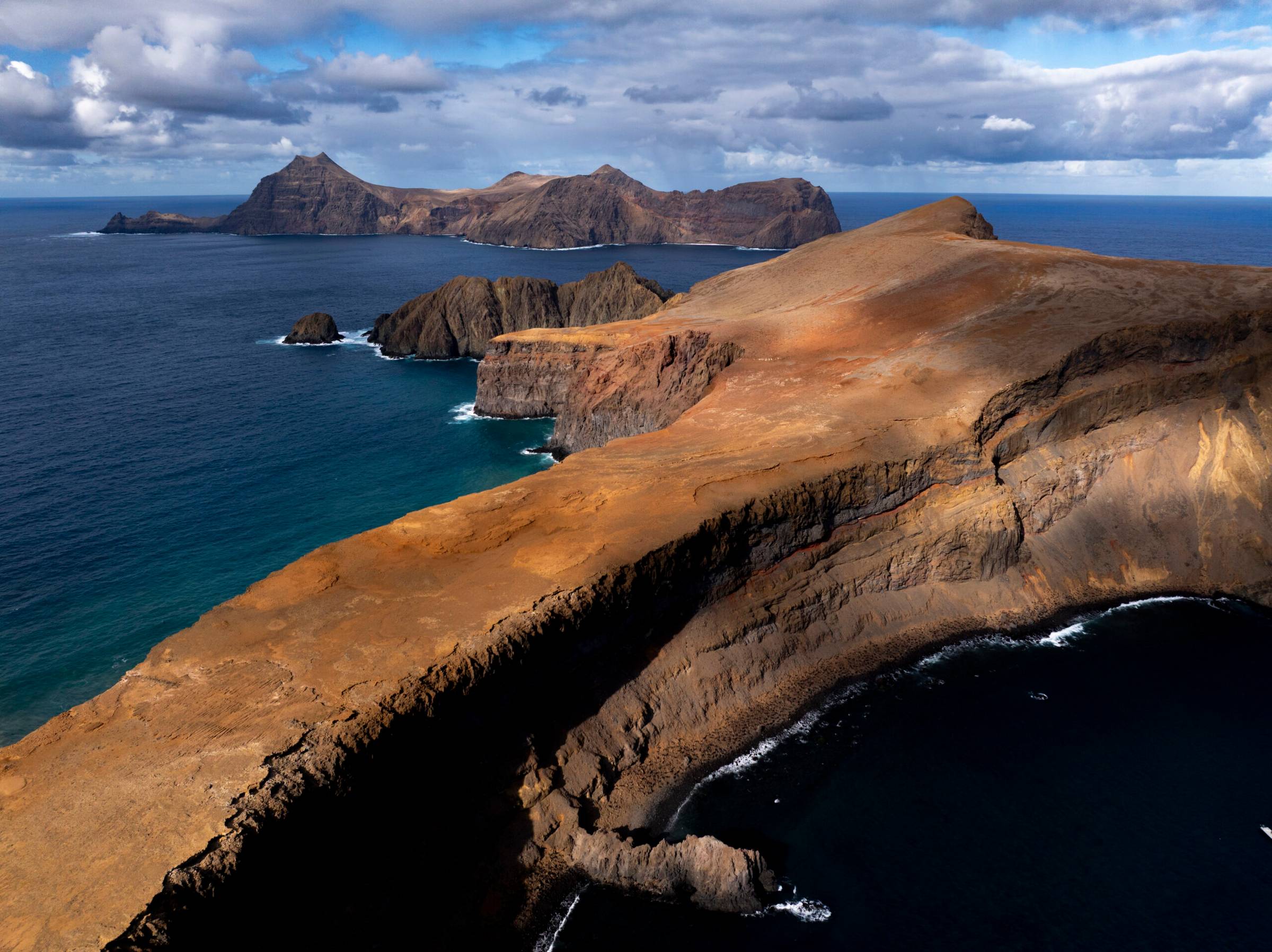 Scenic photo of a rock formation surrounded by water