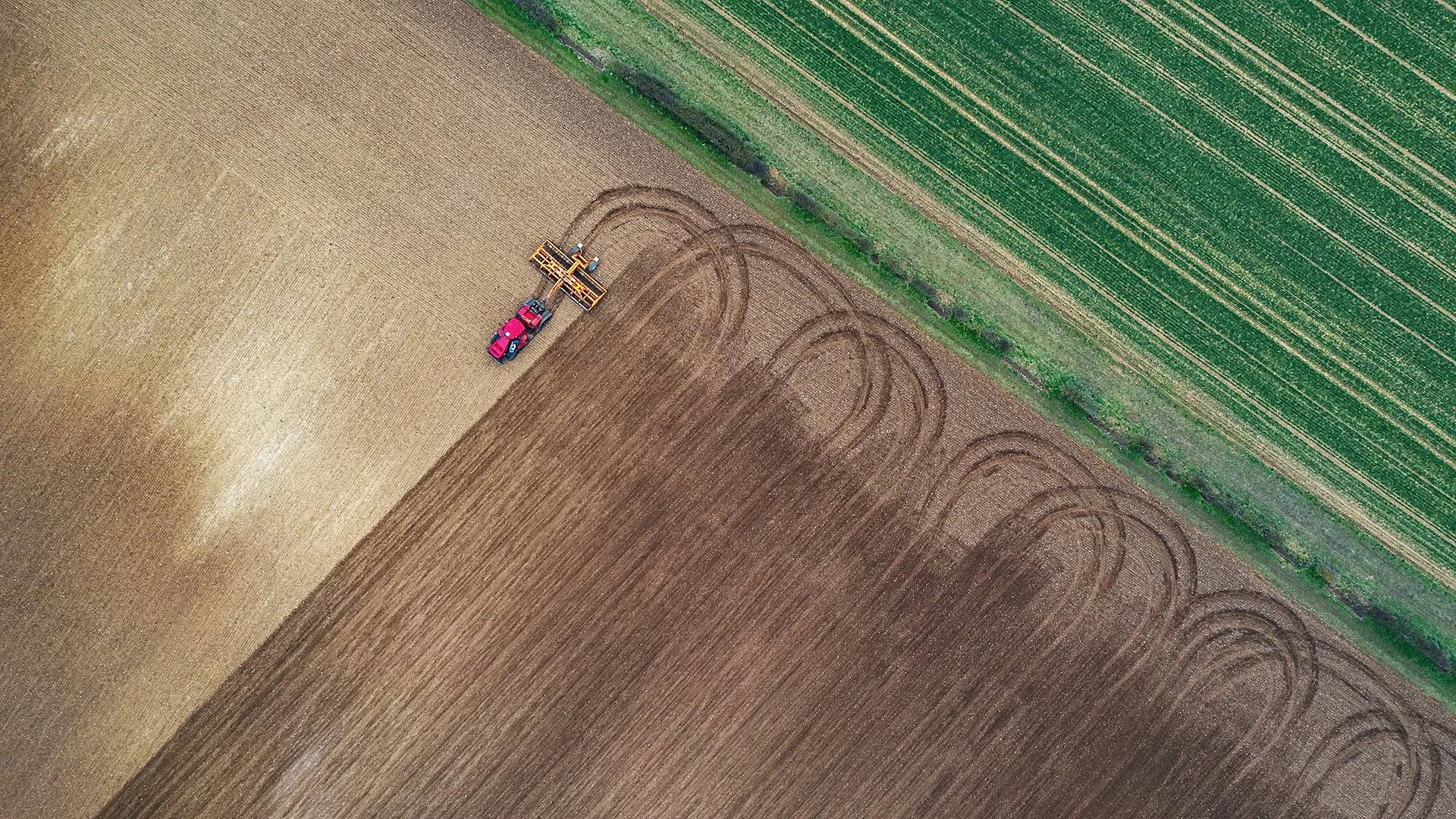Birds-eye view of a tractor in a brown field