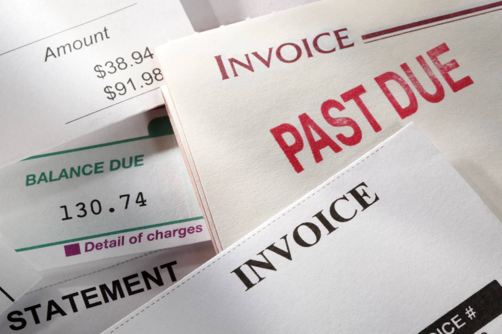 A stock photo of "Past Due" bills and invoices
