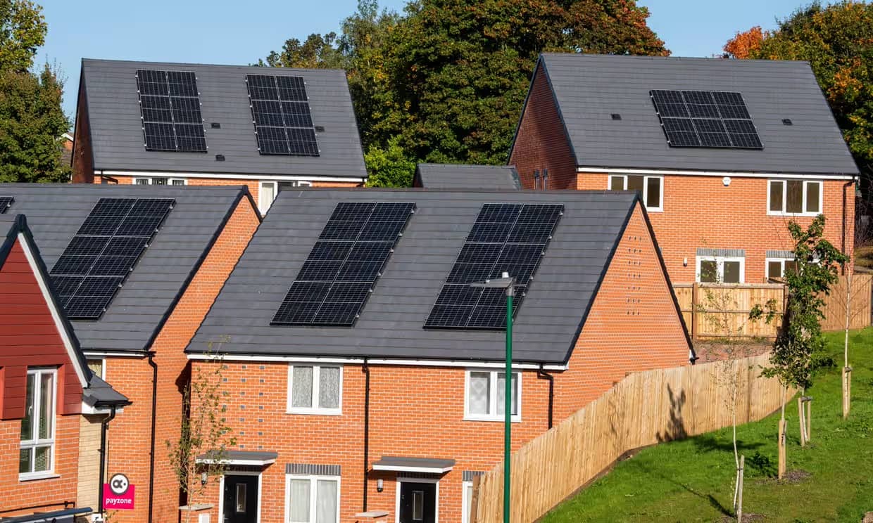 Solar panels on the roofs of orange brick homes
