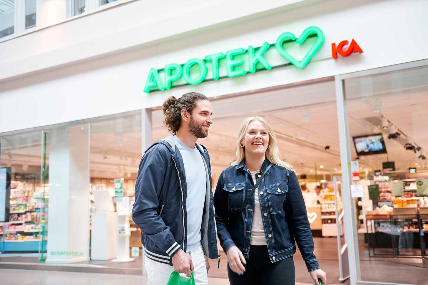 Two people standing in front of a storefront
