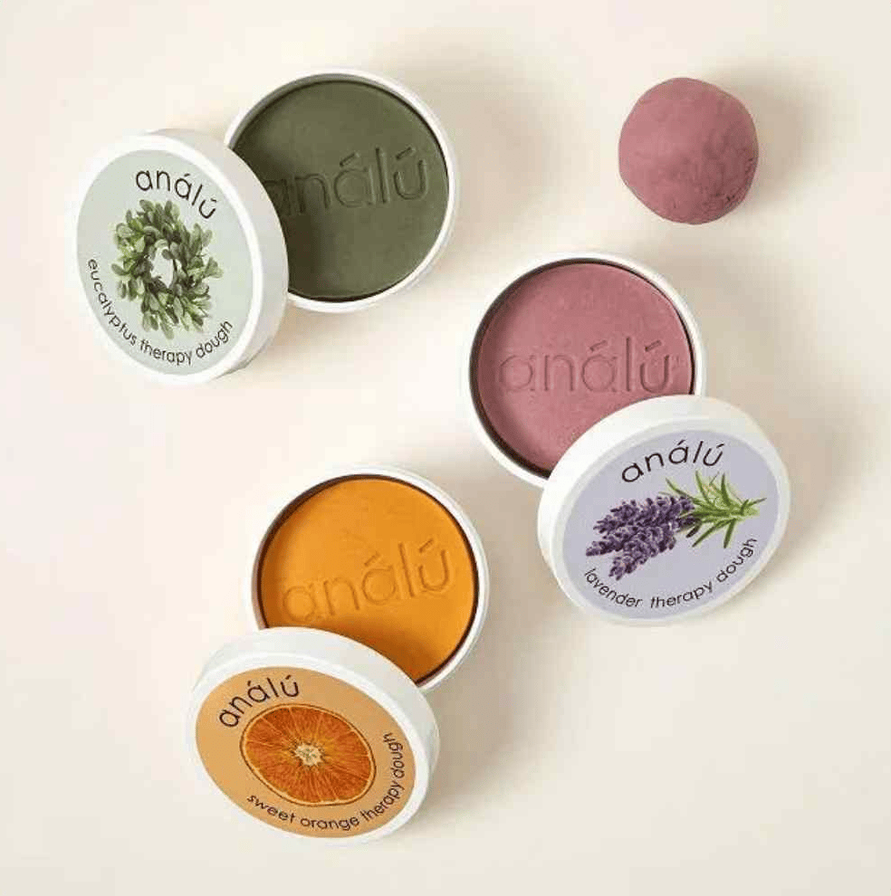 Four tins of colored therapy dough