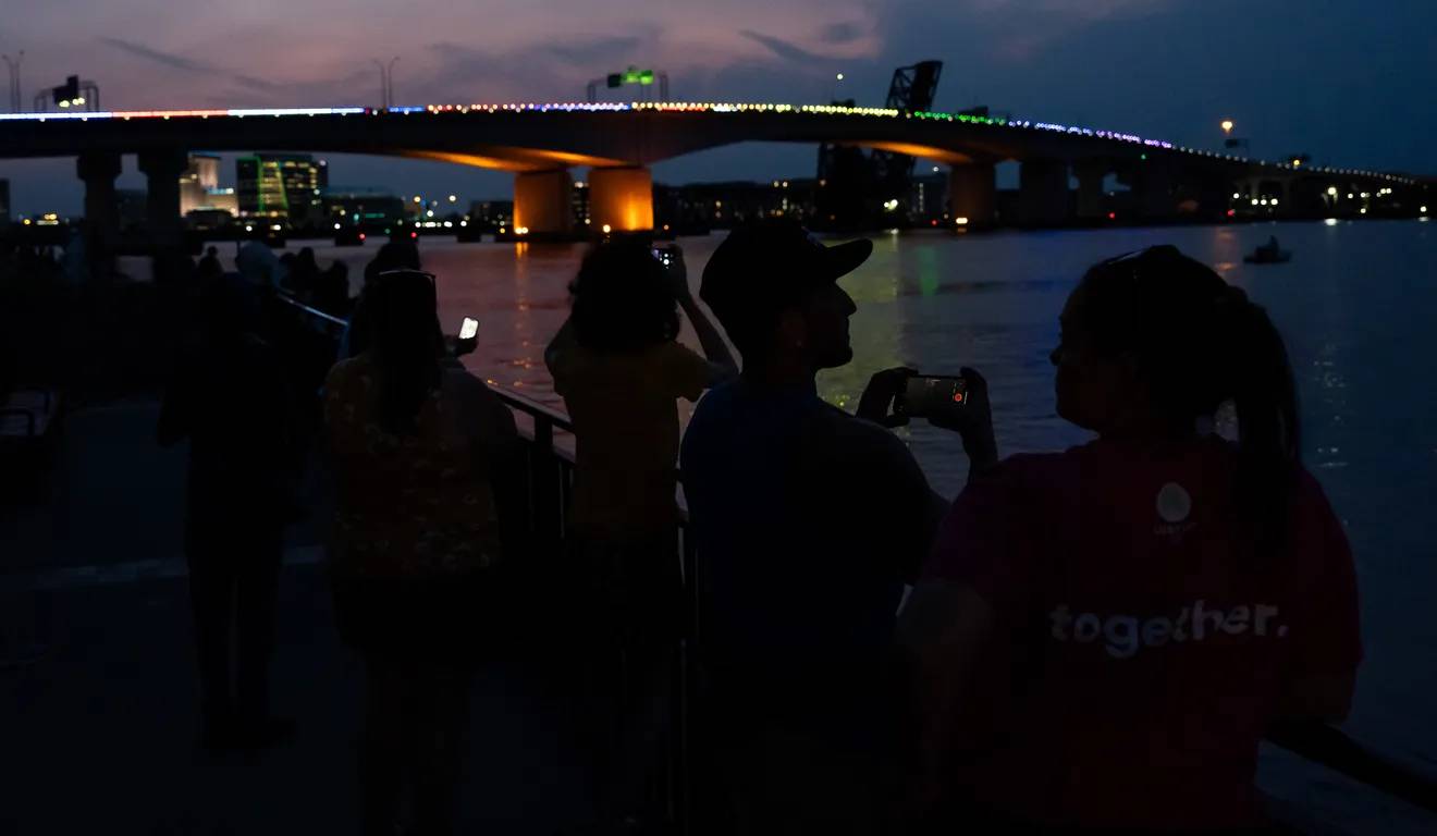 Bands of rainbow lights across the top of a bridge