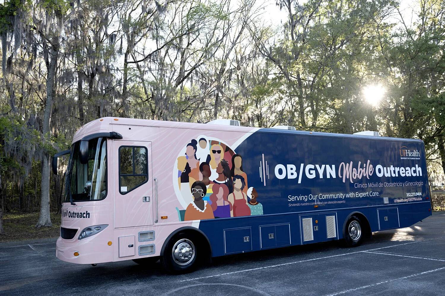 Large bus wrapped in a graphic that says "OB/GYN Mobile Outreach" on the side
