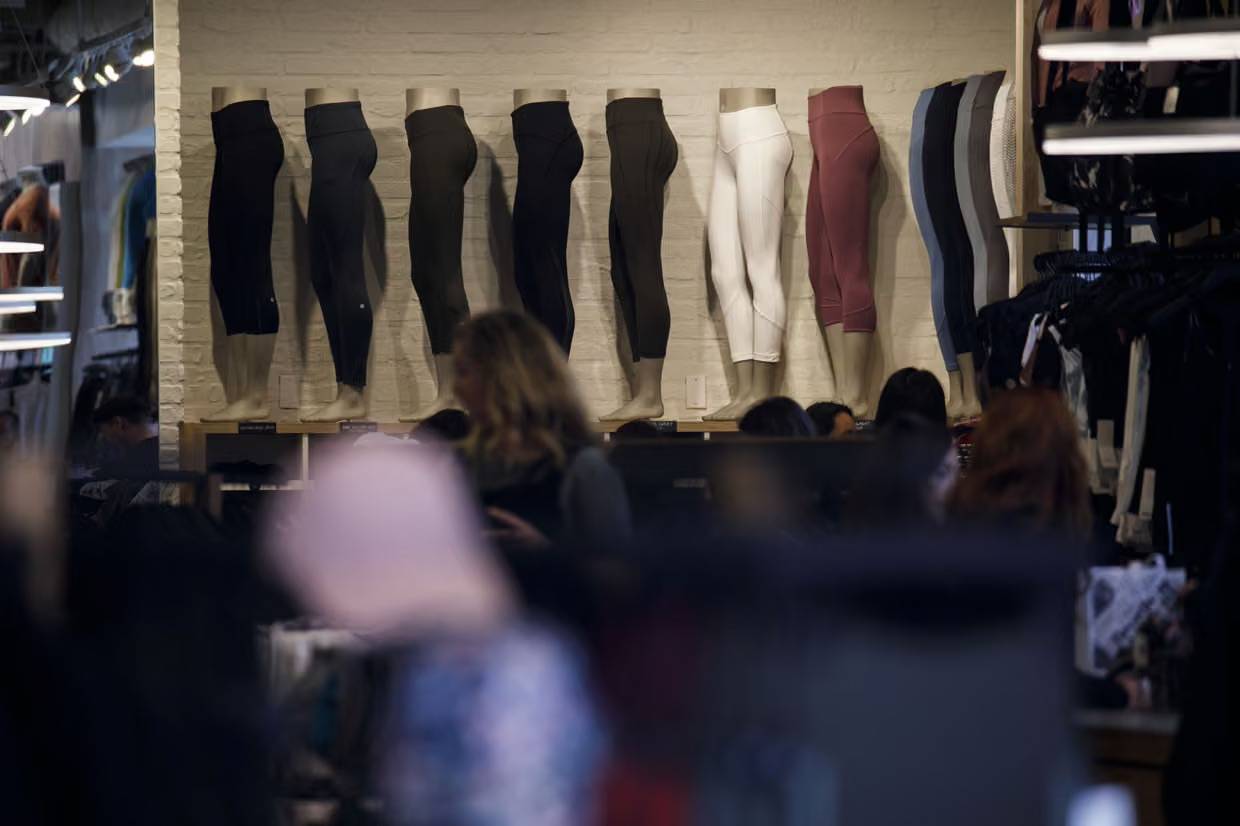 A legging display on a white brick wall inside a store