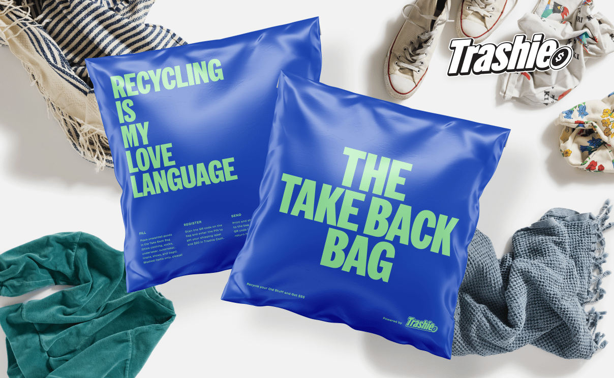 Two blue packaging bags with "The Take Back Bag" and "Recycling is my Love Language" printed in teal on them