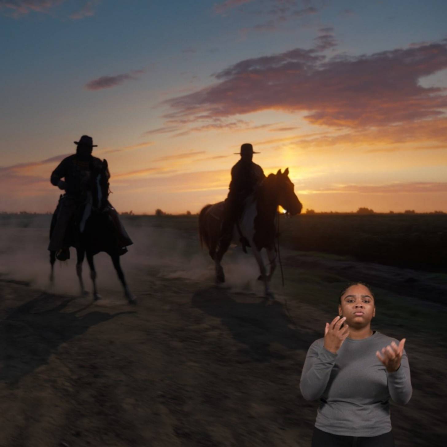 Person in a grey shirt in bottom right corner of image signing BASL with two people on horseback against a sunrise in the background