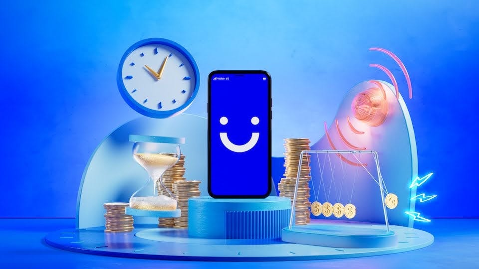 Graphic in blue tones, there's a clock, hourglass, stacks of coins, and a martphone with a blue screen and white smiley face Visible logo on it