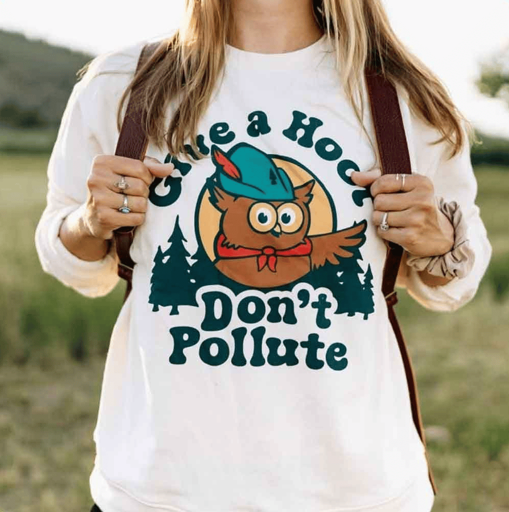 Person wearing a shirt that says "Give a hoot, don't pollute"