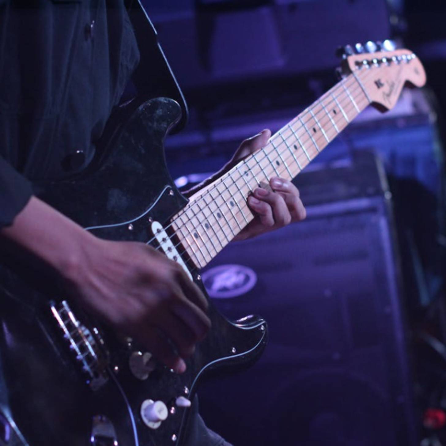 Person playing an electric guitar