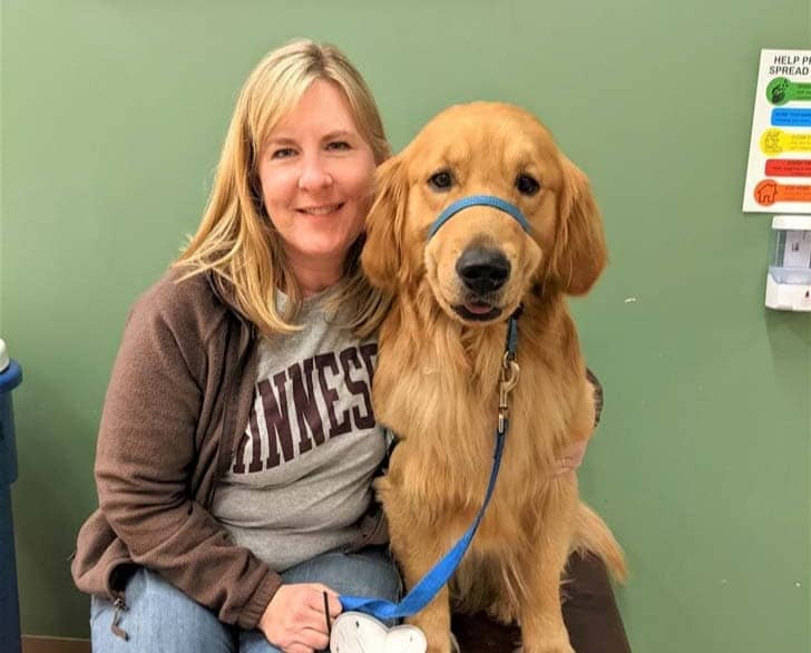 Melissa Hortman sitting with her golden retriever, Gilbert