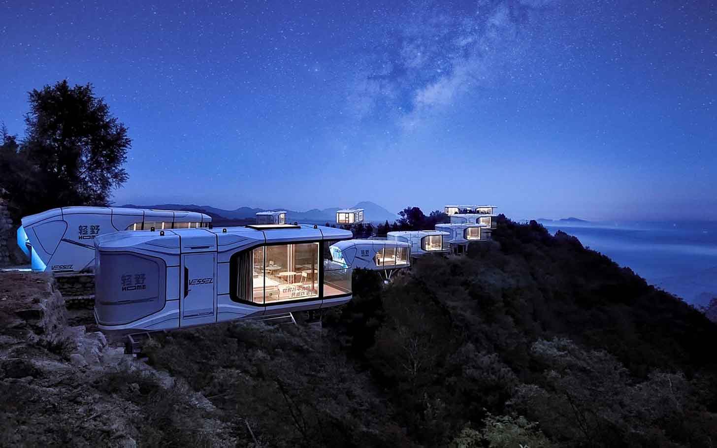 Capsule homes on a cliffside at night