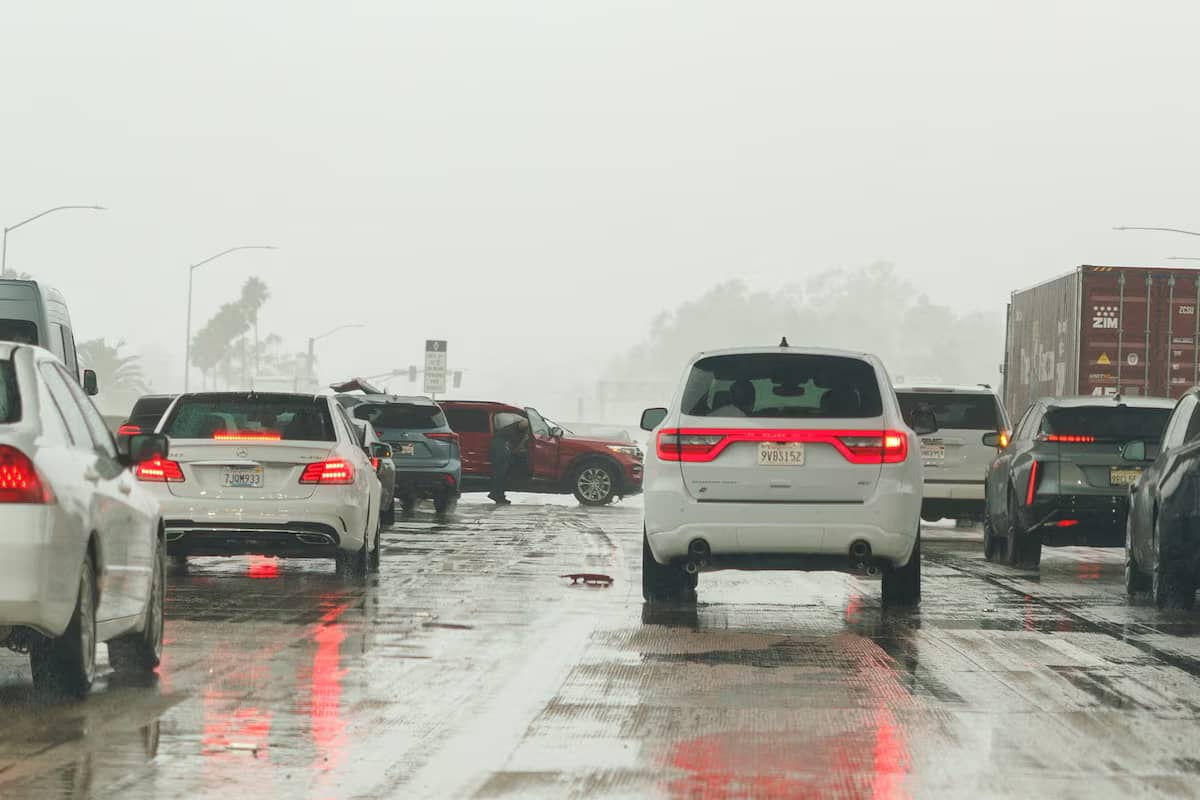 Cars on a roadway with one situated perpendicular to traffic