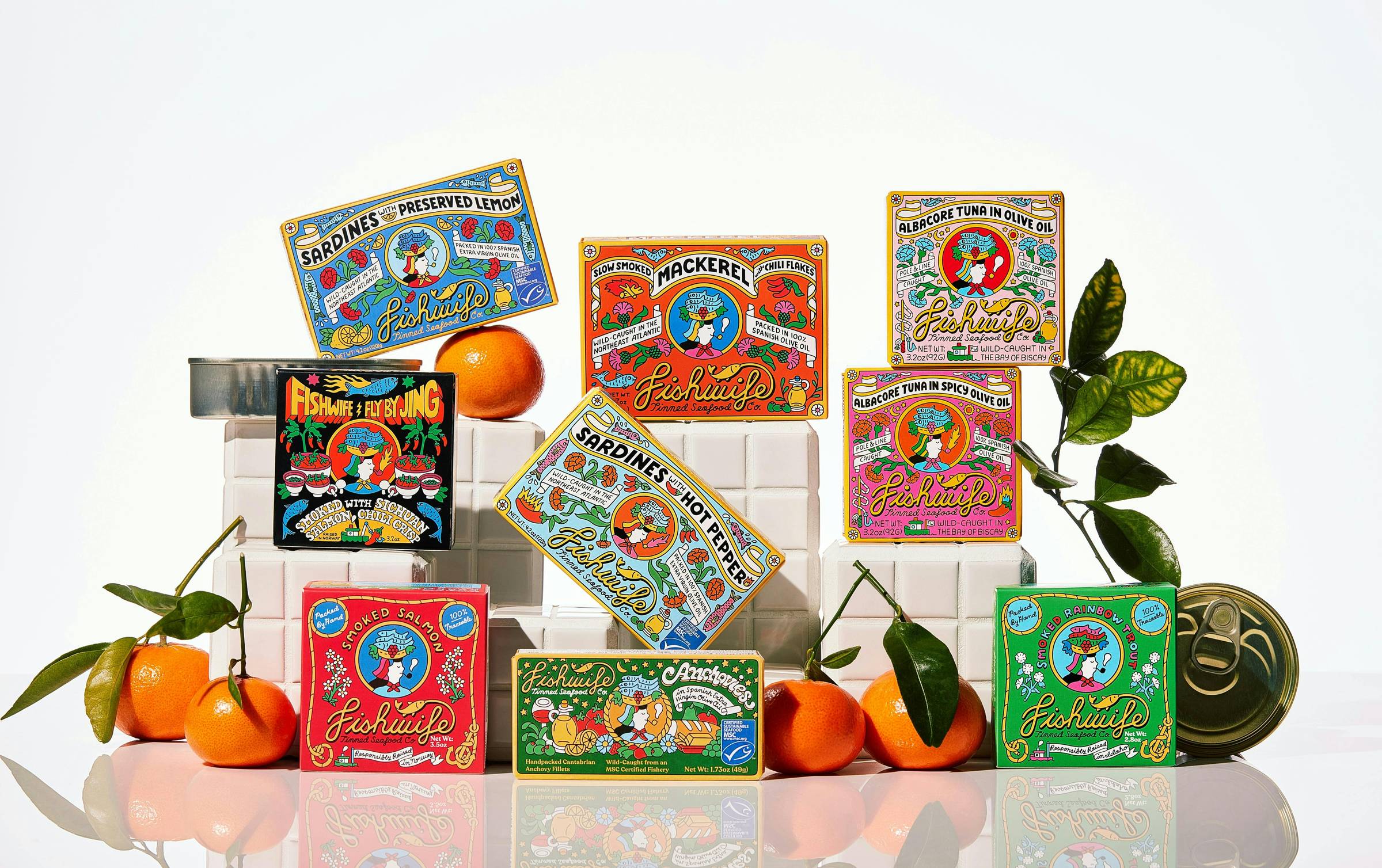 Various tins of fishwife sardines, tuna, and other varieties in colorfully designed packages artfully displayed