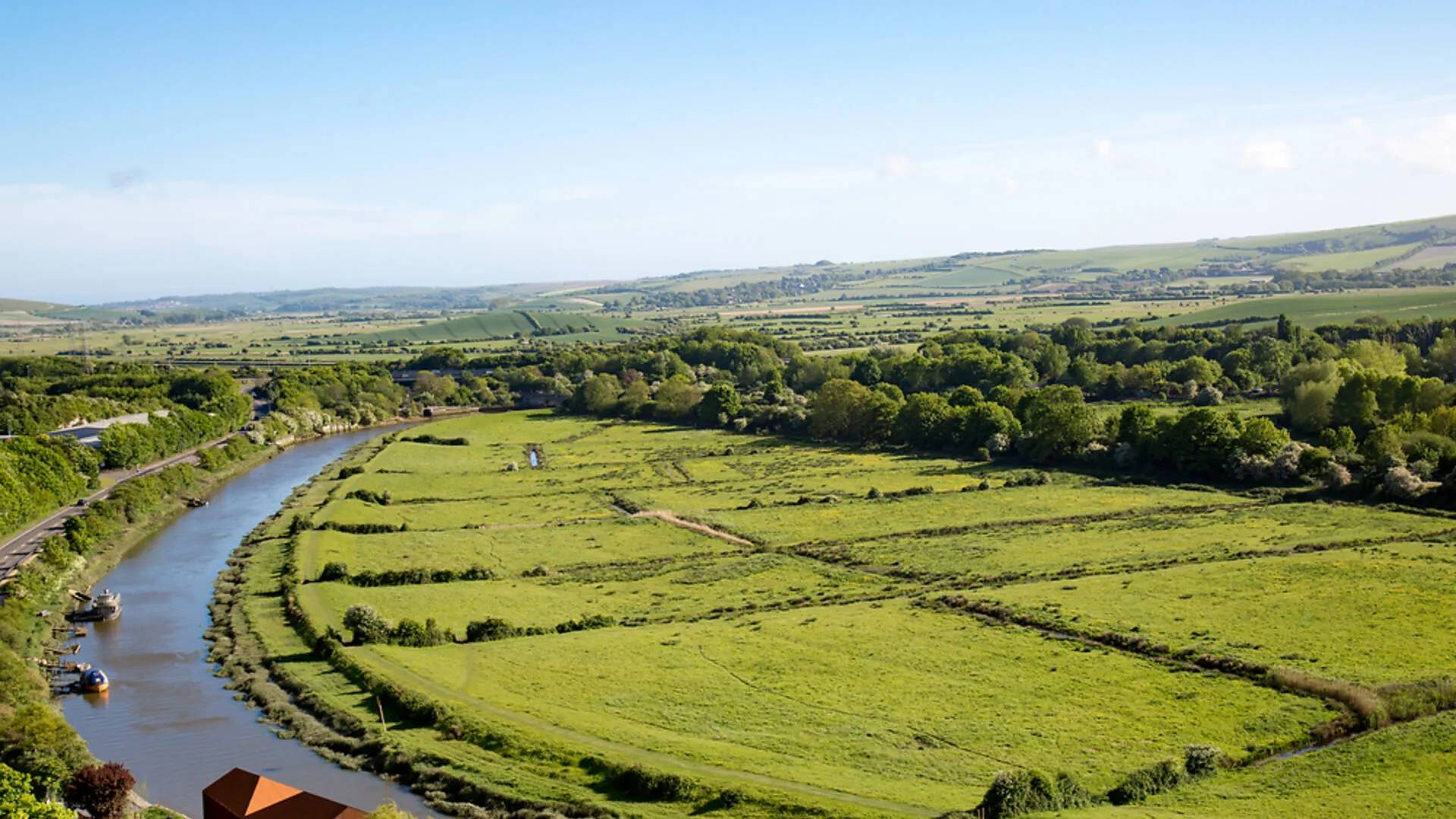 A river winding through green fields