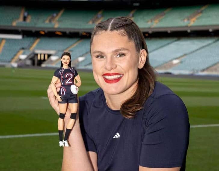 Ilona Maher posing with her Barbie doll