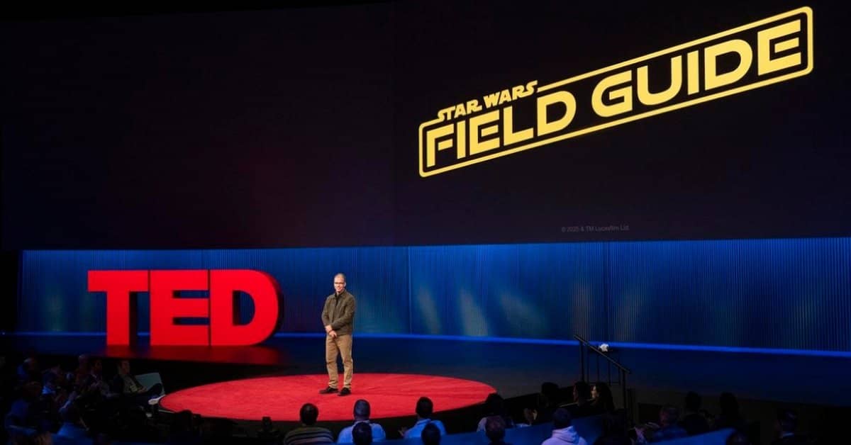 A speaker on the TED stage with "Star Wars Field Guide" on the screen behind them