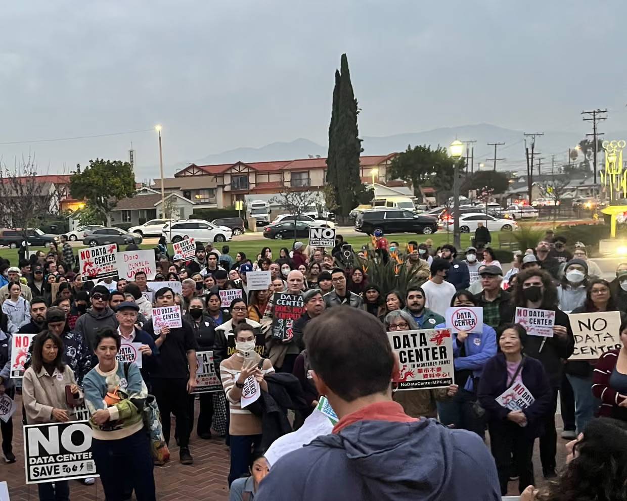 A group of people holding "No data center" signs at a gathering