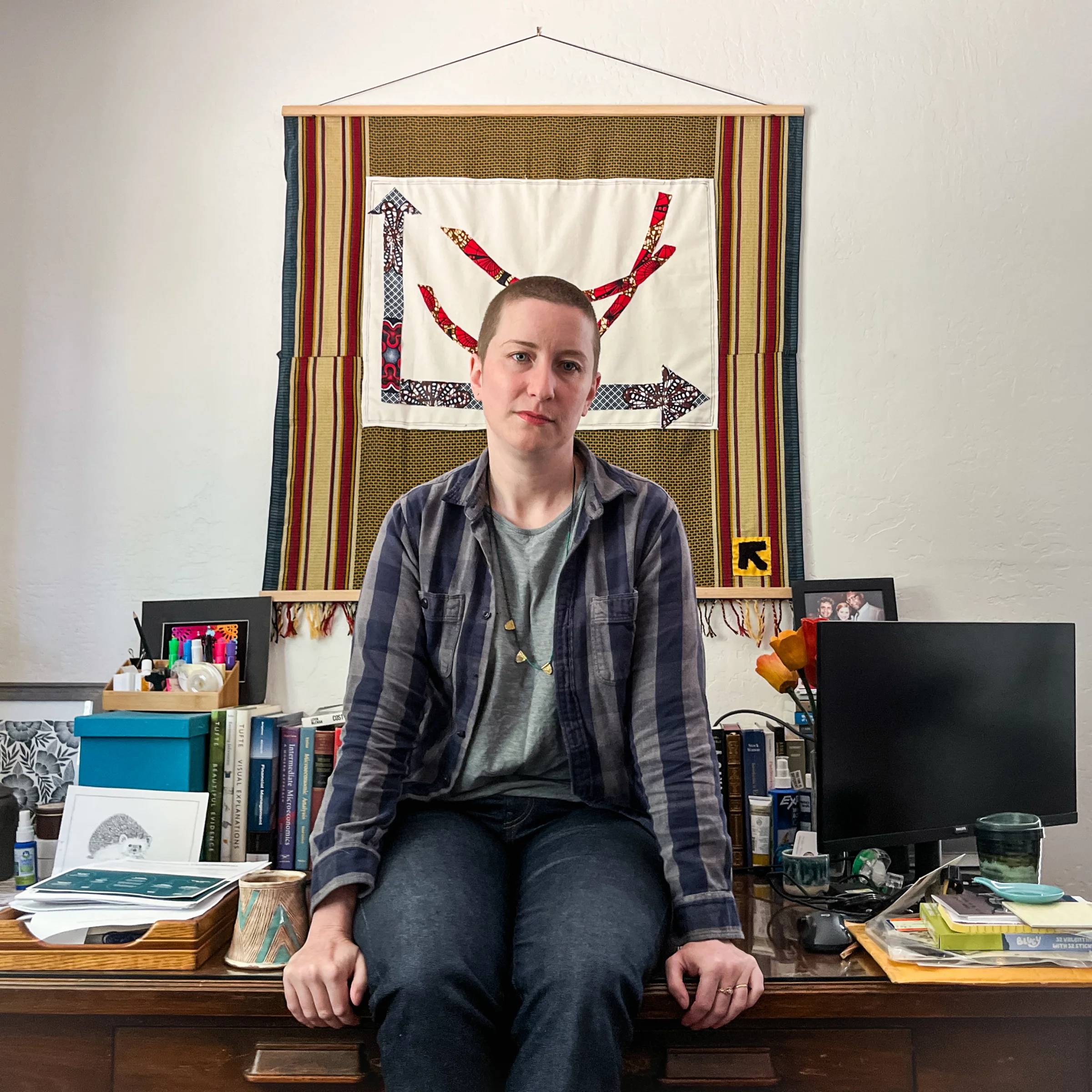 Caitlin Tulloch sitting on her desk in her home office