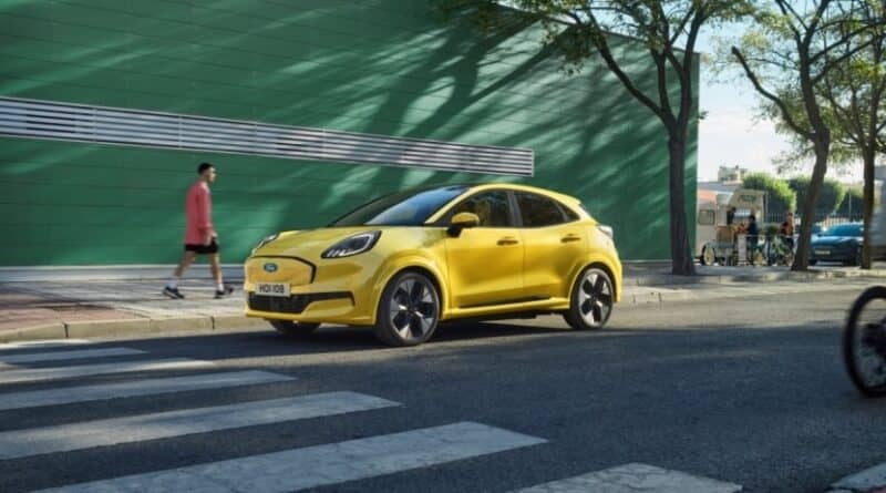 Yellow Ford car parked on the side of a road