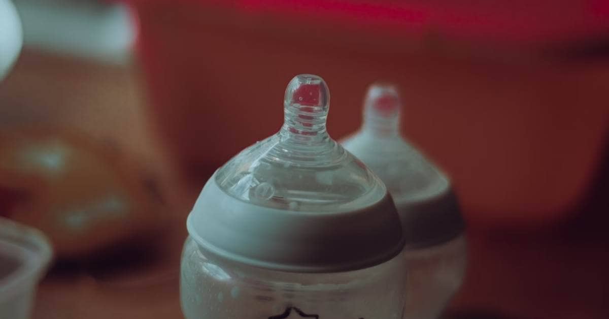 The tops of two baby bottles