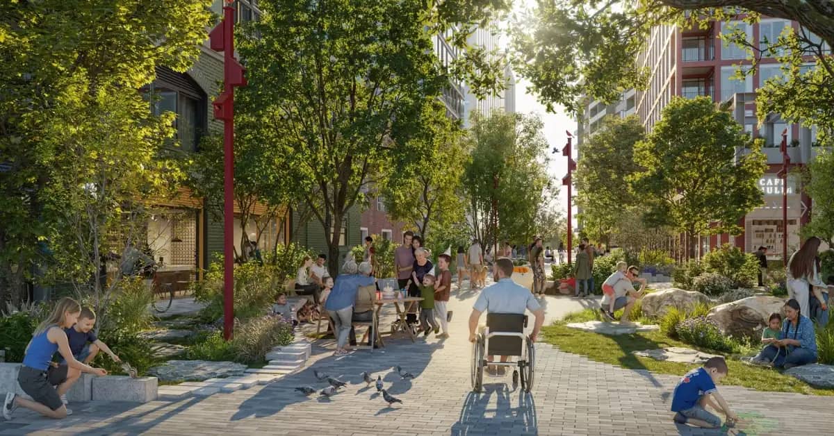 Rendering of a pedestrian street lined with trees and multi-story buildings, where dozens of people walk, sit, and play among paved pathways and green spaces. A person pushes a stroller down the center of the street.