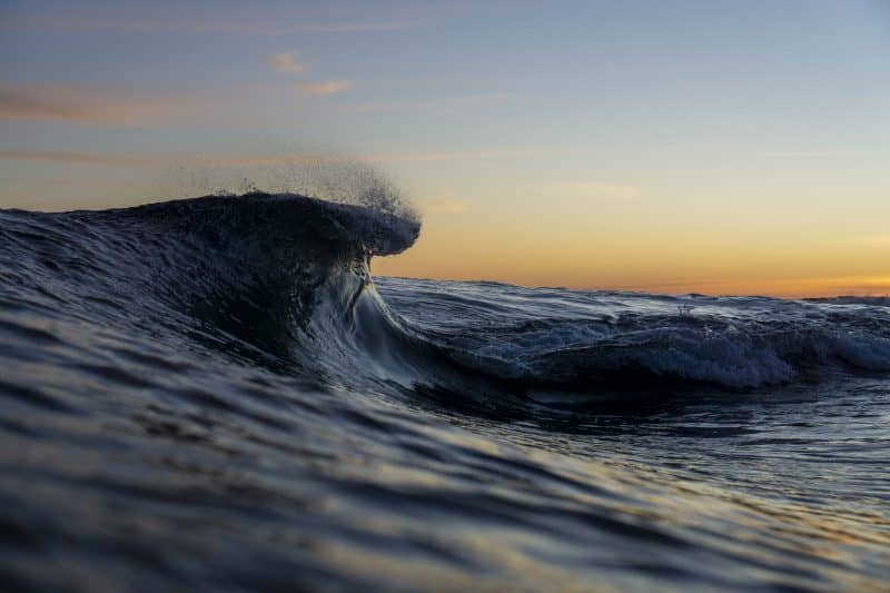 An ocean wave at sunrise or sunset 